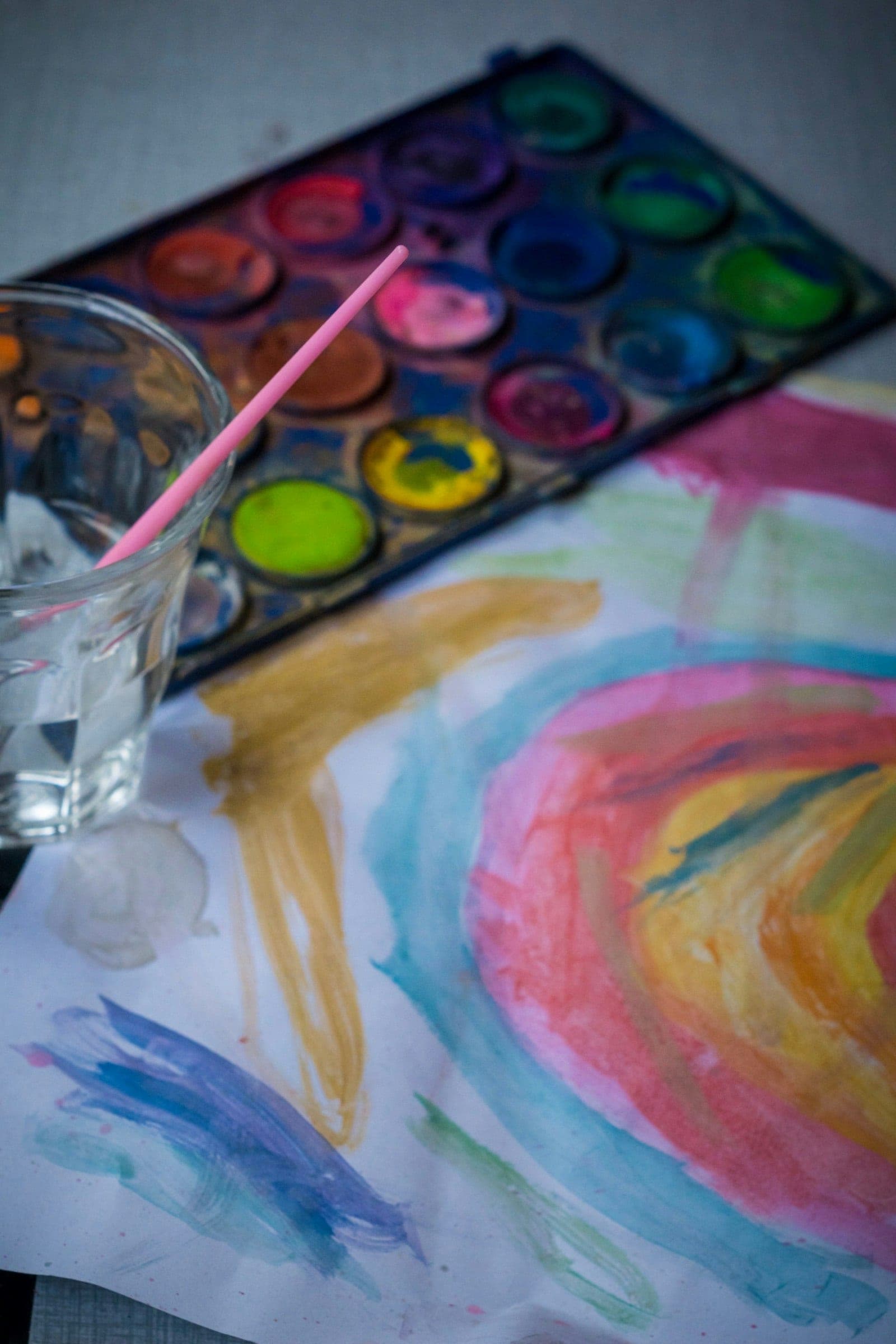 A child's watercolor painting and paint palette